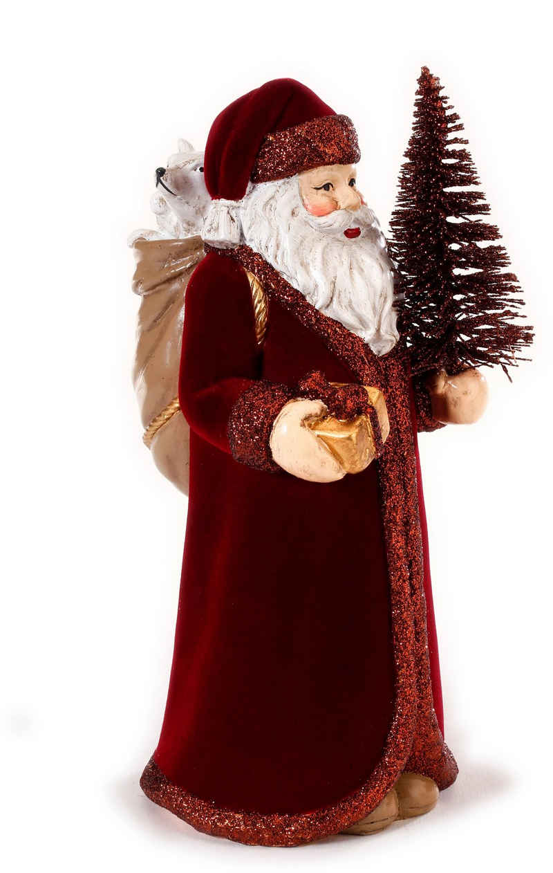 CHRISTMAS GOODS by Inge Weihnachtsmann Weihnachtsdeko (1 St), mit Baum und Geschenk, Höhe ca. 22,5 cm