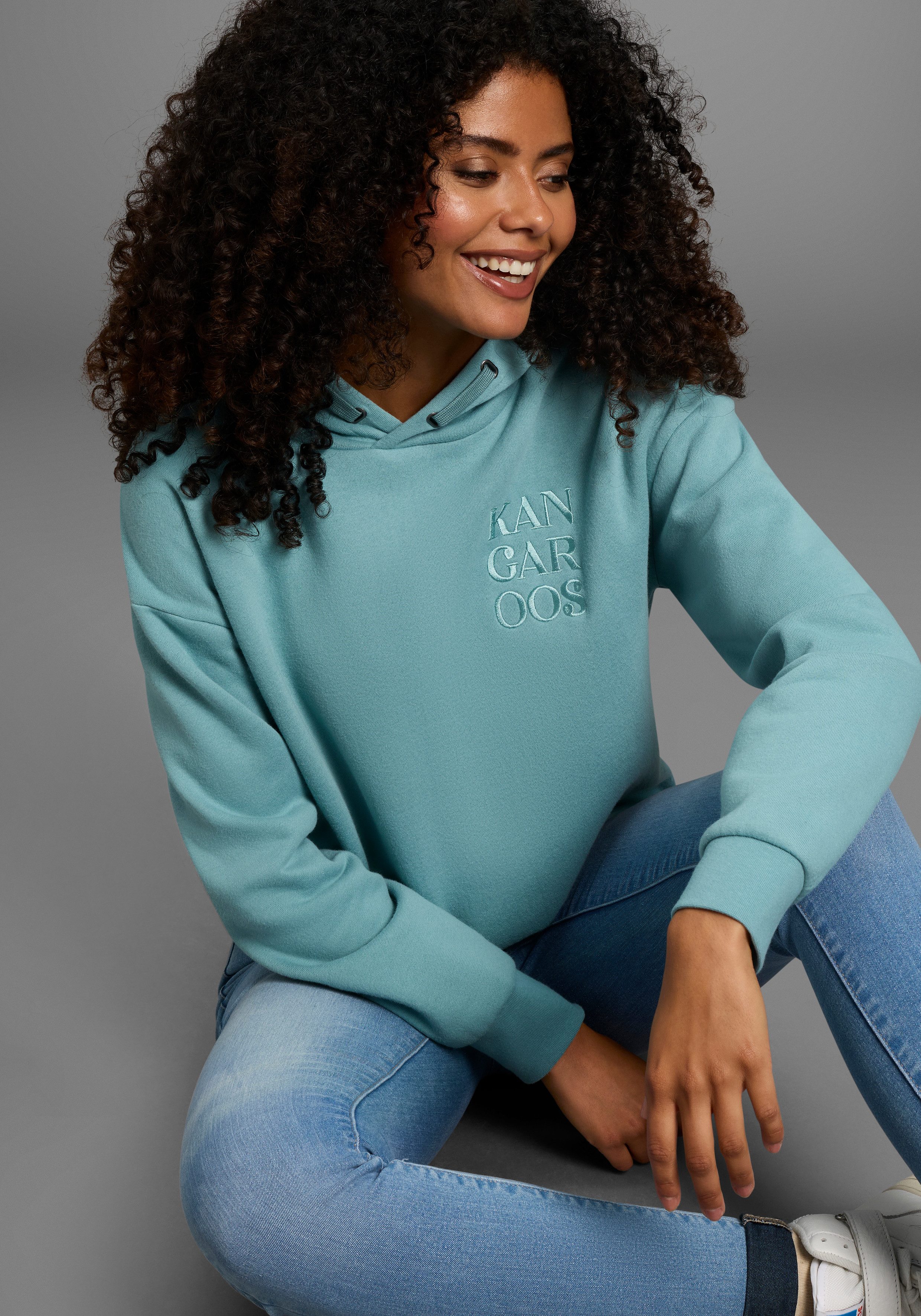 KangaROOS Kapuzensweatshirt mit Druckknöpfen am Saum günstig online kaufen