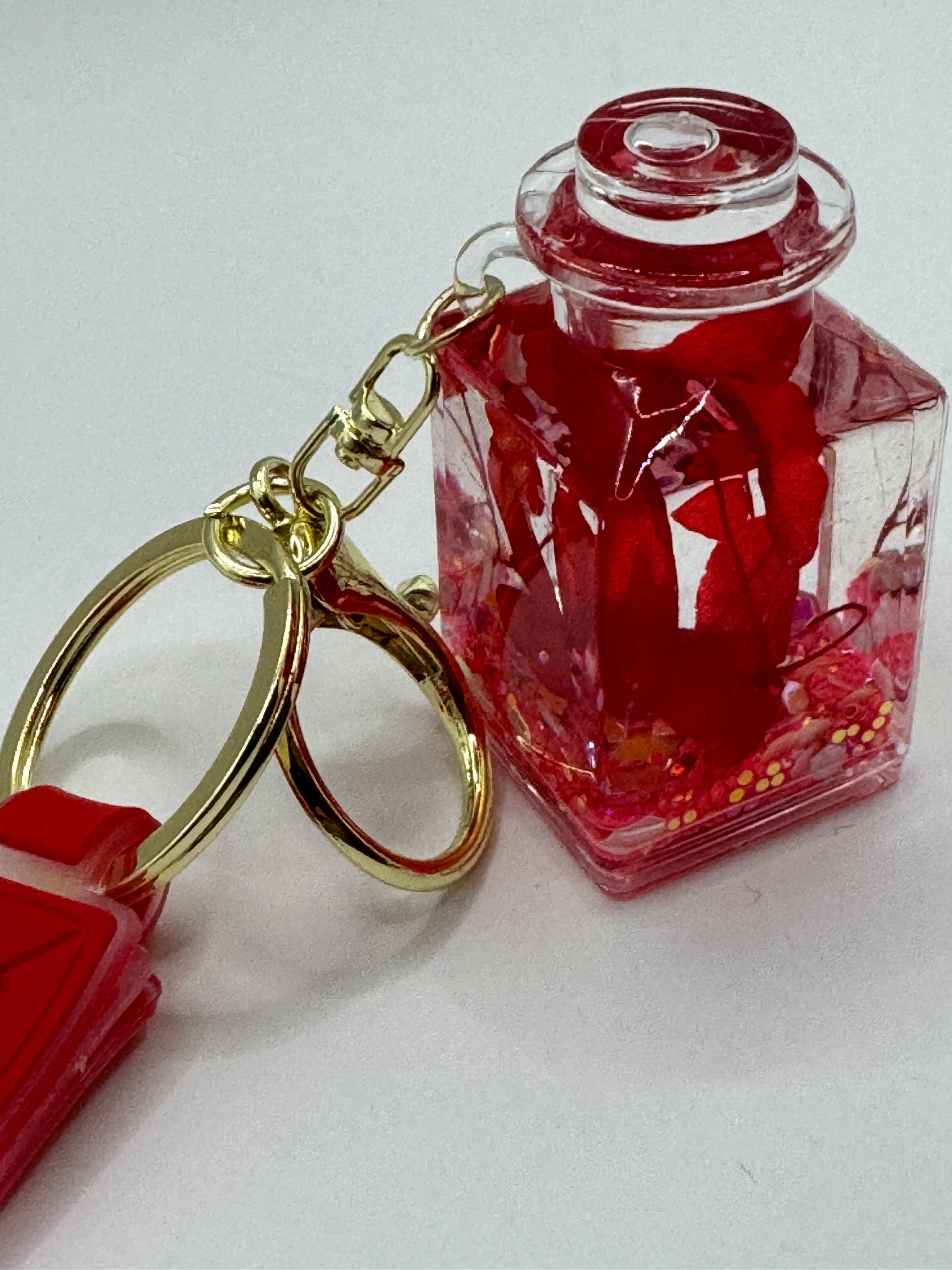 Stelby Schlüsselanhänger Romantischer Flaschen-Schlüsselanhänger mit Blume & Glitzerdeko, Acryl-Fläschchen mit Kunstblume, Glitzer & stabilem Metallring