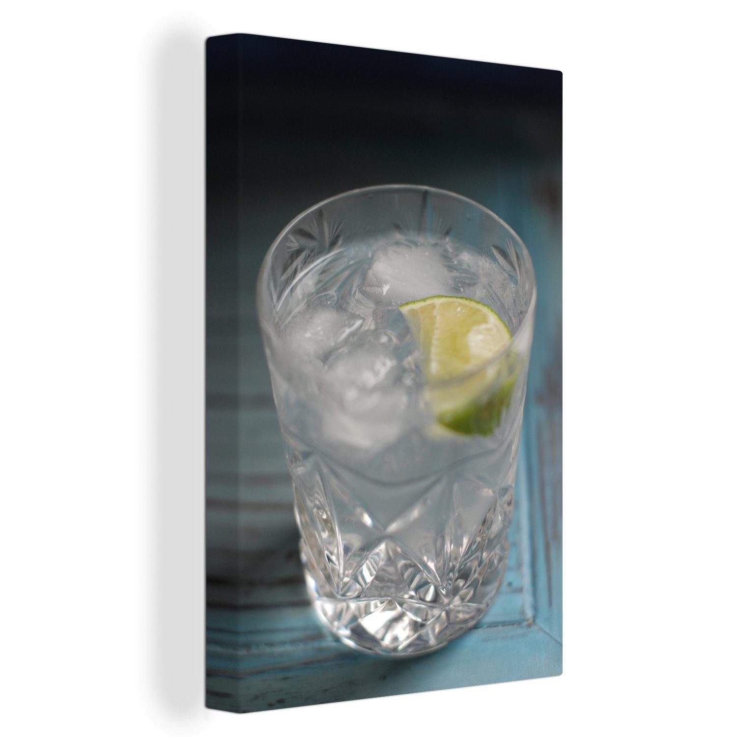 OneMillionCanvasses® Leinwandbild Ein Gin einem Tisch, Zackenaufhänger, Tonic fertig inkl. St), Leinwandbild blauen bespannt 20x30 (1 Gemälde, cm auf