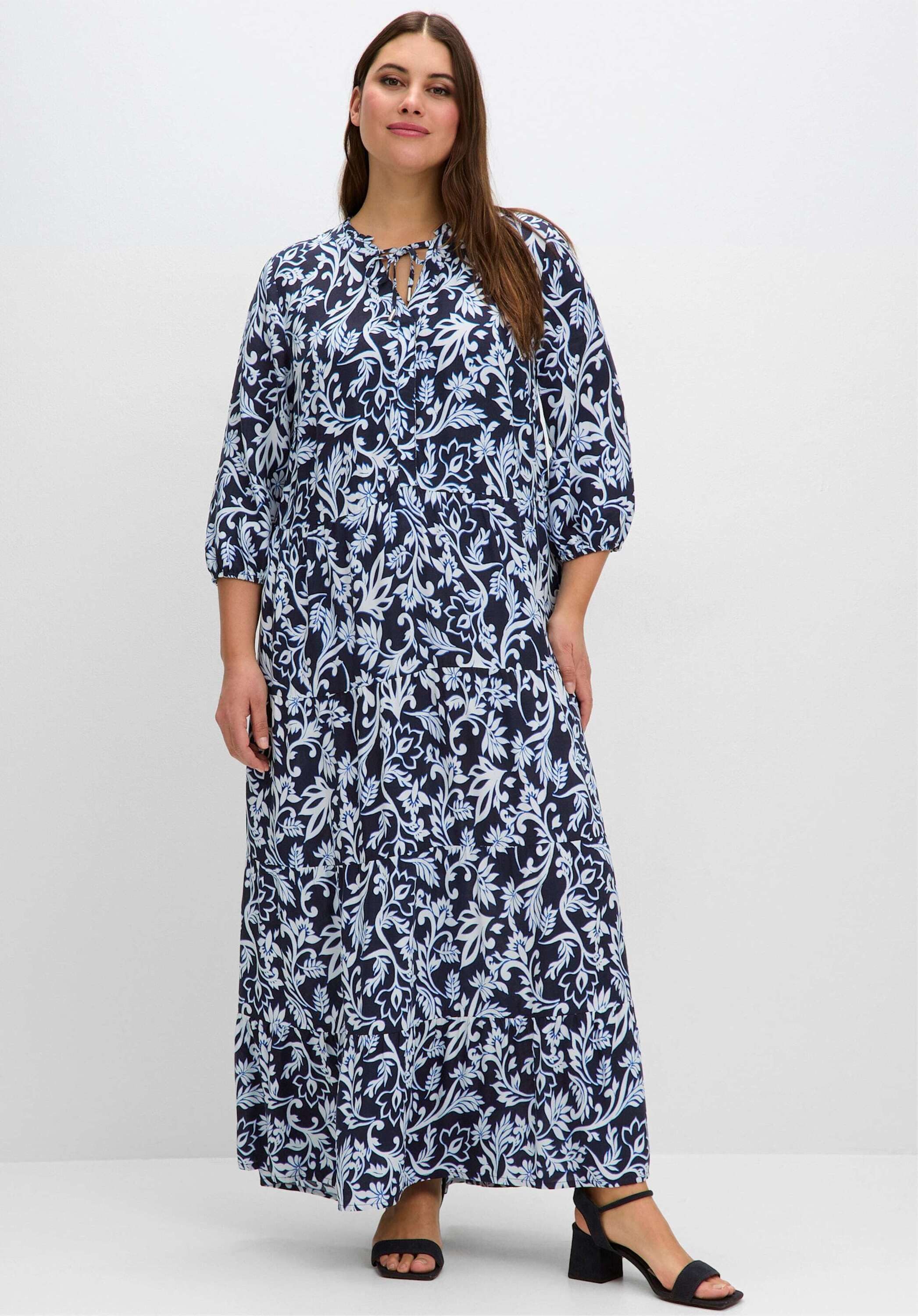 Sheego Etuikleid Maxikleid 3/4-Arm mit floralem Druck und gestuftem Rock günstig online kaufen