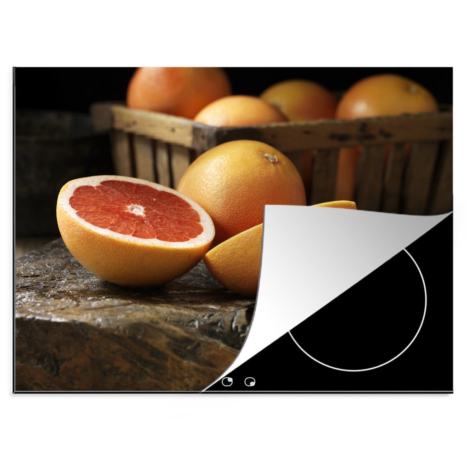 MuchoWow Herdblende-/Abdeckplatte Frische Grapefruit in einem Korb auf einem Holztisch, Vinyl, (1 tlg), 70x52 cm, Mobile Arbeitsfläche nutzbar, Ceranfeldabdeckung