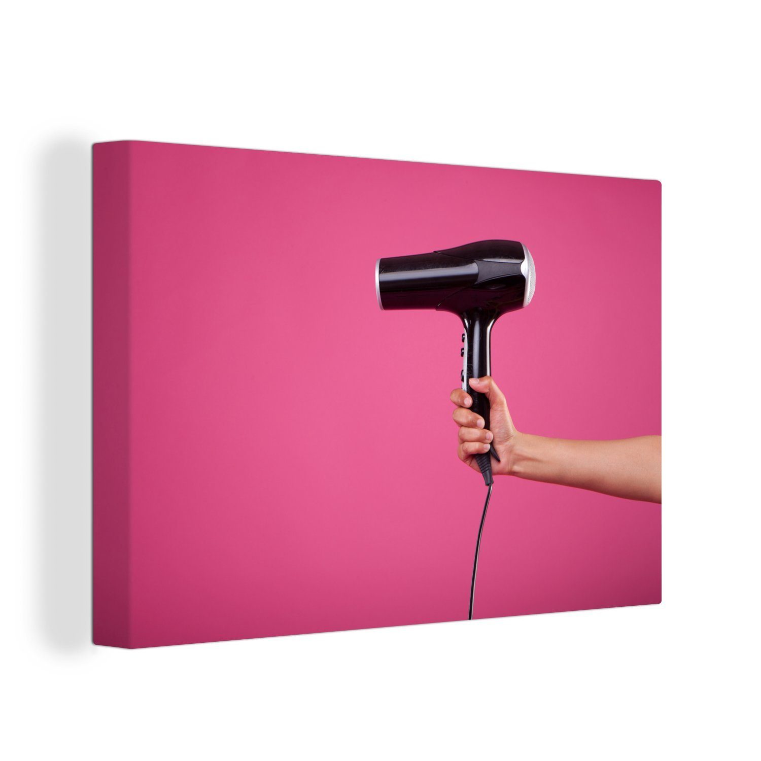 OneMillionCanvasses® Leinwandbild Ein schwarzer Haartrockner auf einem rosa Hintergrund, (1 St), Wandbild Leinwandbilder, Aufhängefertig, Wanddeko, 30x20 cm
