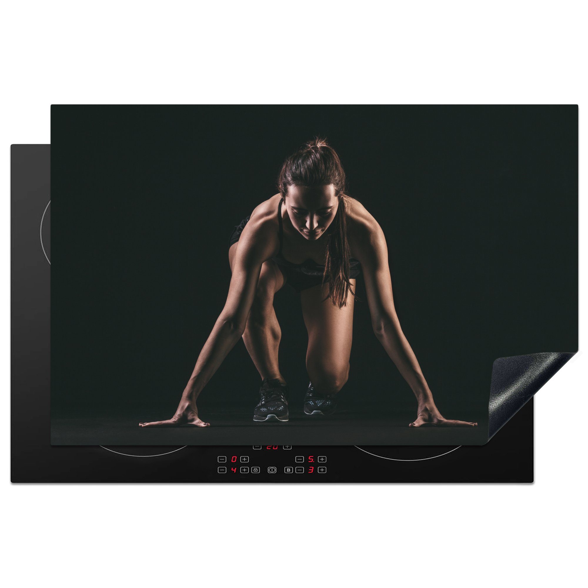 MuchoWow Herdblende-/Abdeckplatte Weibliche Athletin auf schwarzem Hintergrund, Vinyl, (1 tlg), 81x52 cm, Induktionskochfeld Schutz für die küche, Ceranfeldabdeckung