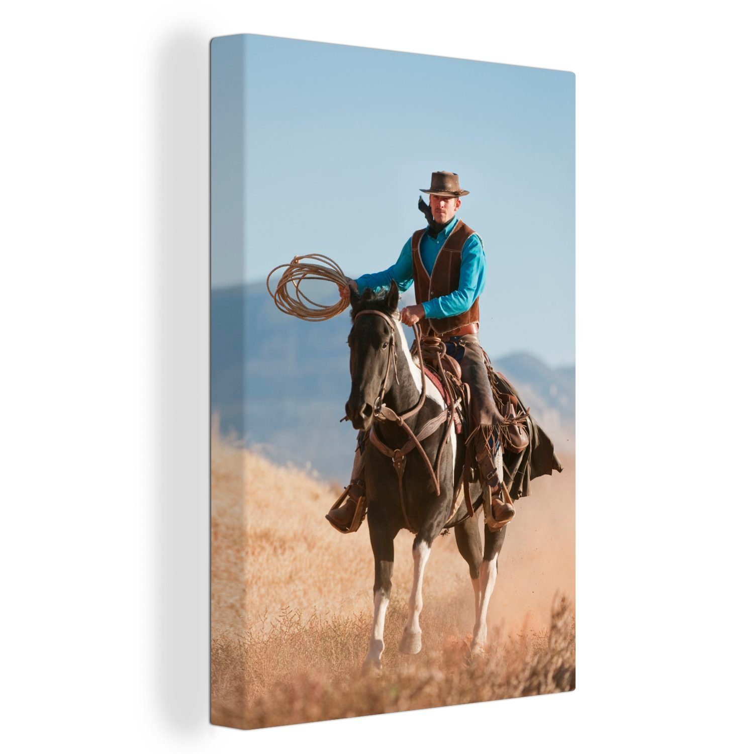 OneMillionCanvasses® Leinwandbild Ein Cowboy auf einem Pferd vor einem grauen Himmel, (1 St), Leinwandbild fertig bespannt inkl. Zackenaufhänger, Gemälde, 20x30 cm