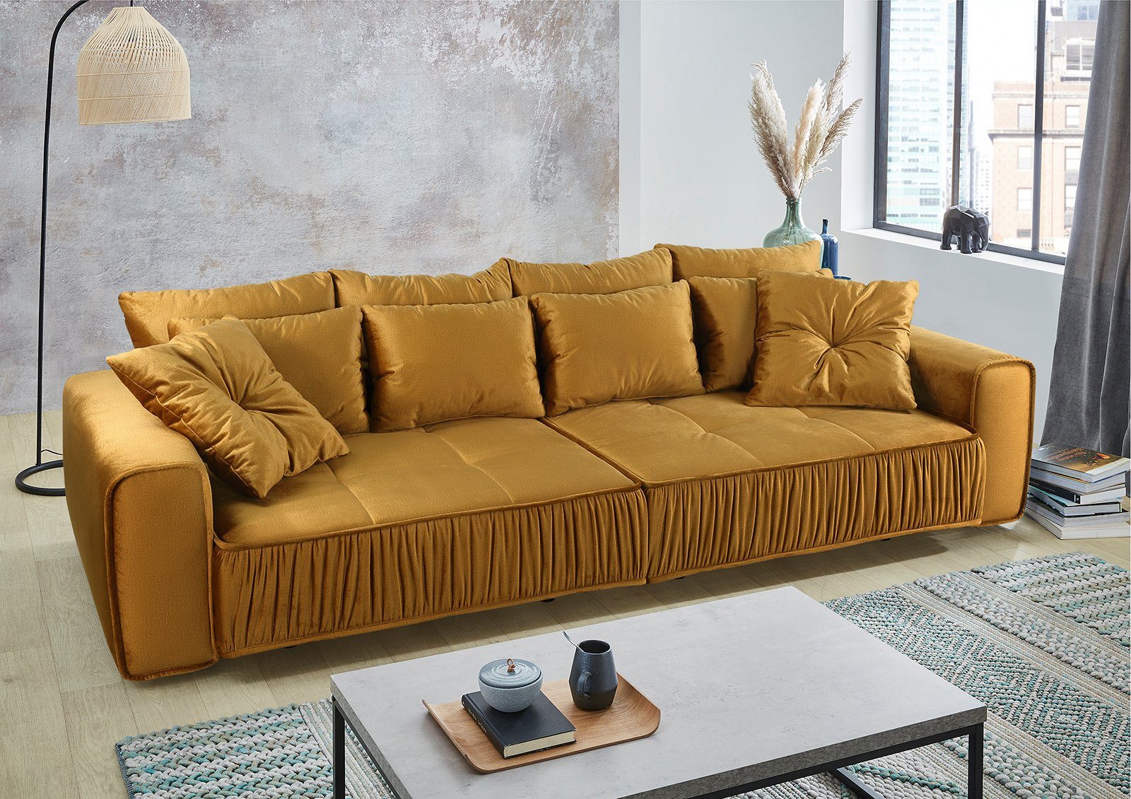 Places of Style Big-Sofa, mit schwebender Optik und künstlerischer Raffung an der vorderen Kante, Federkernpolsterung, frei im Raum stellbar-HomeTrends