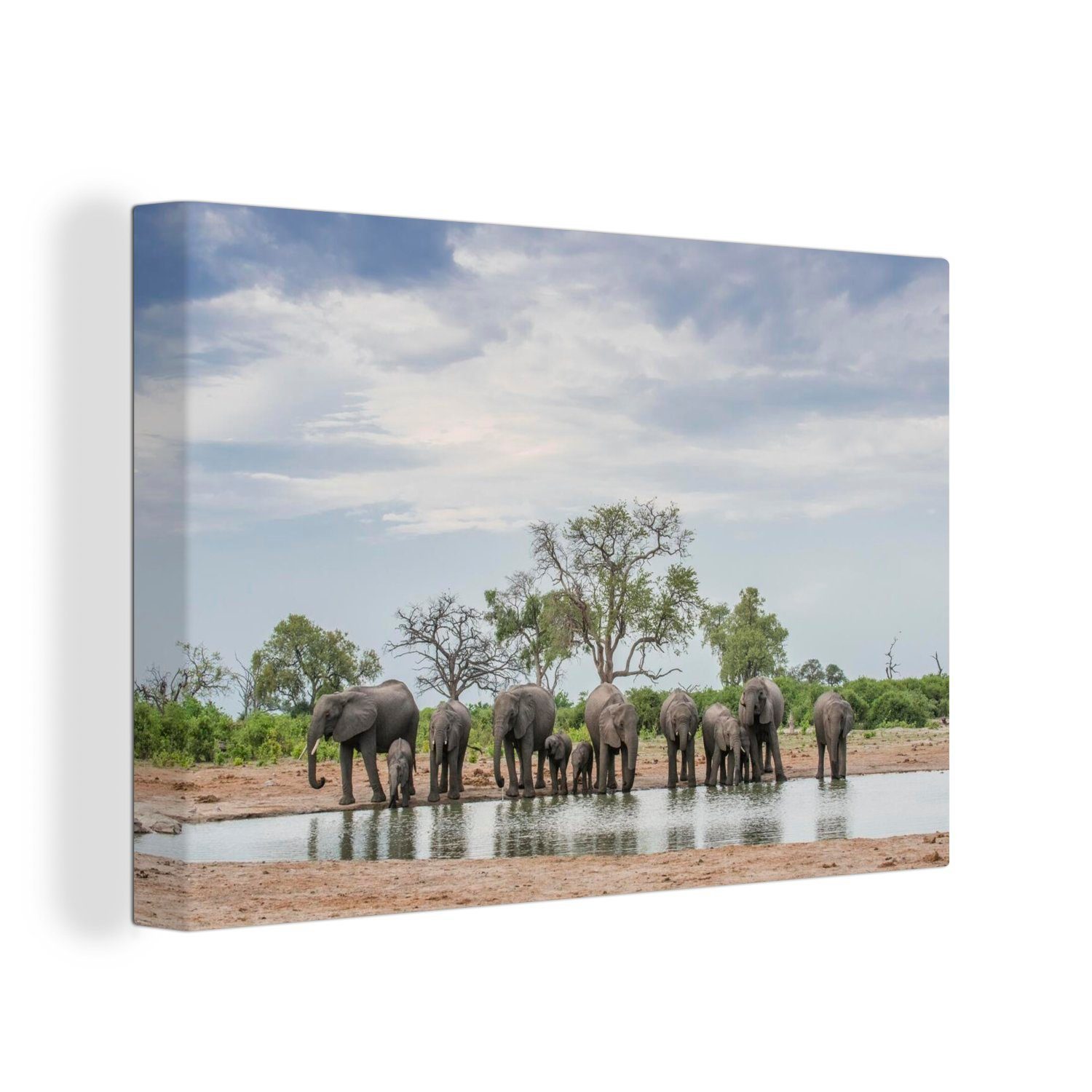 OneMillionCanvasses® Leinwandbild Afrikanische Elefanten trinken an einem Brunnen, (1 St), Wandbild Leinwandbilder, Aufhängefertig, Wanddeko, 30x20 cm