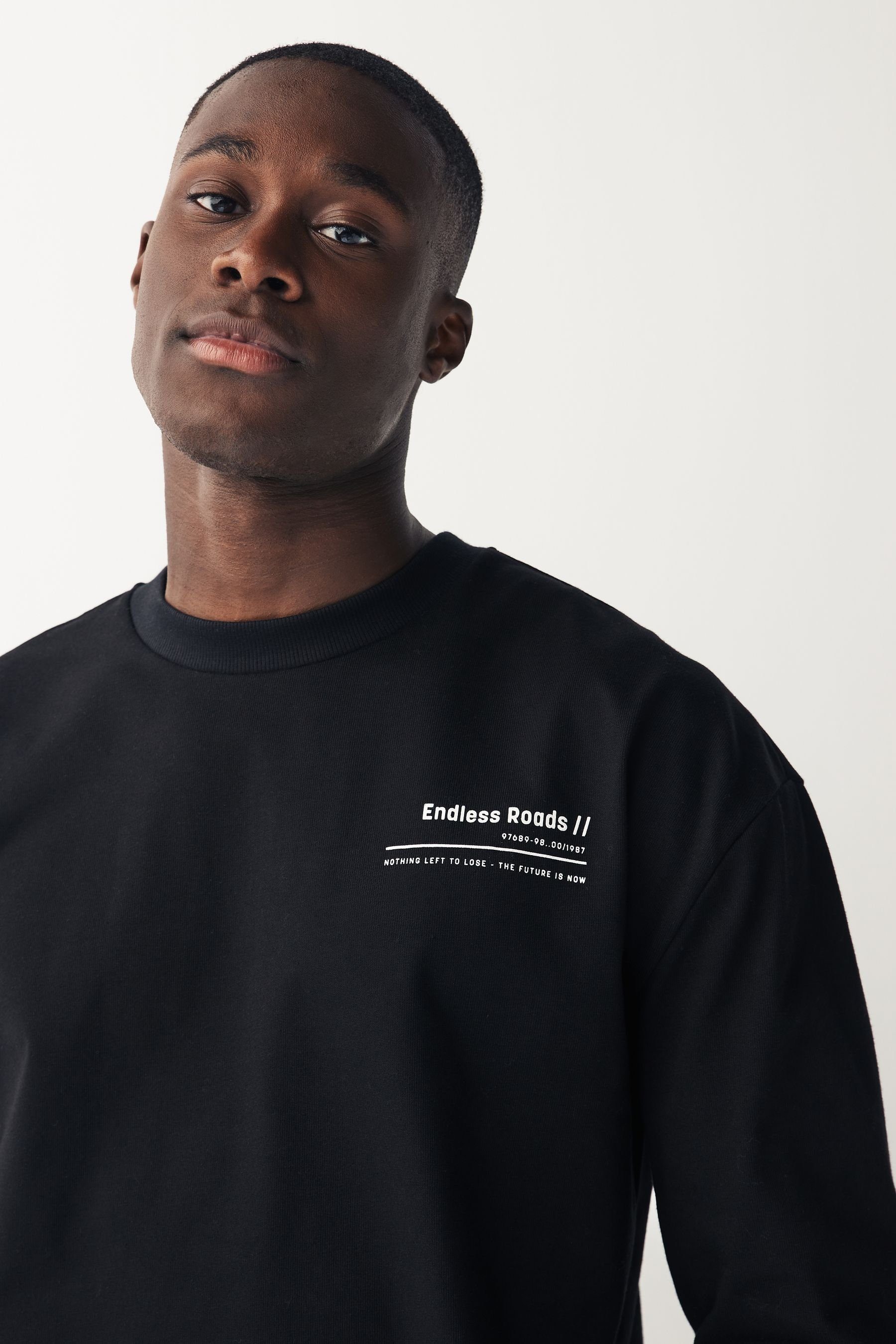 Ärmeln (1-tlg) langen und Black Next mit Langarmshirt Grafik-Shirt Rückenprint