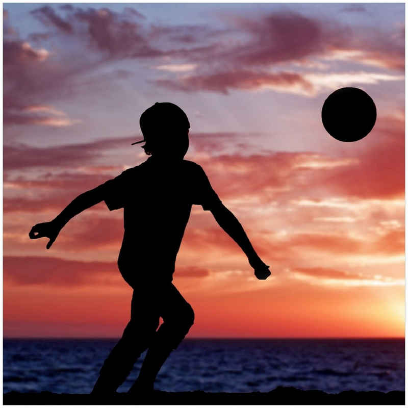 Wallario Memoboard Fußball - Kleiner Junge spielt im Abendrot