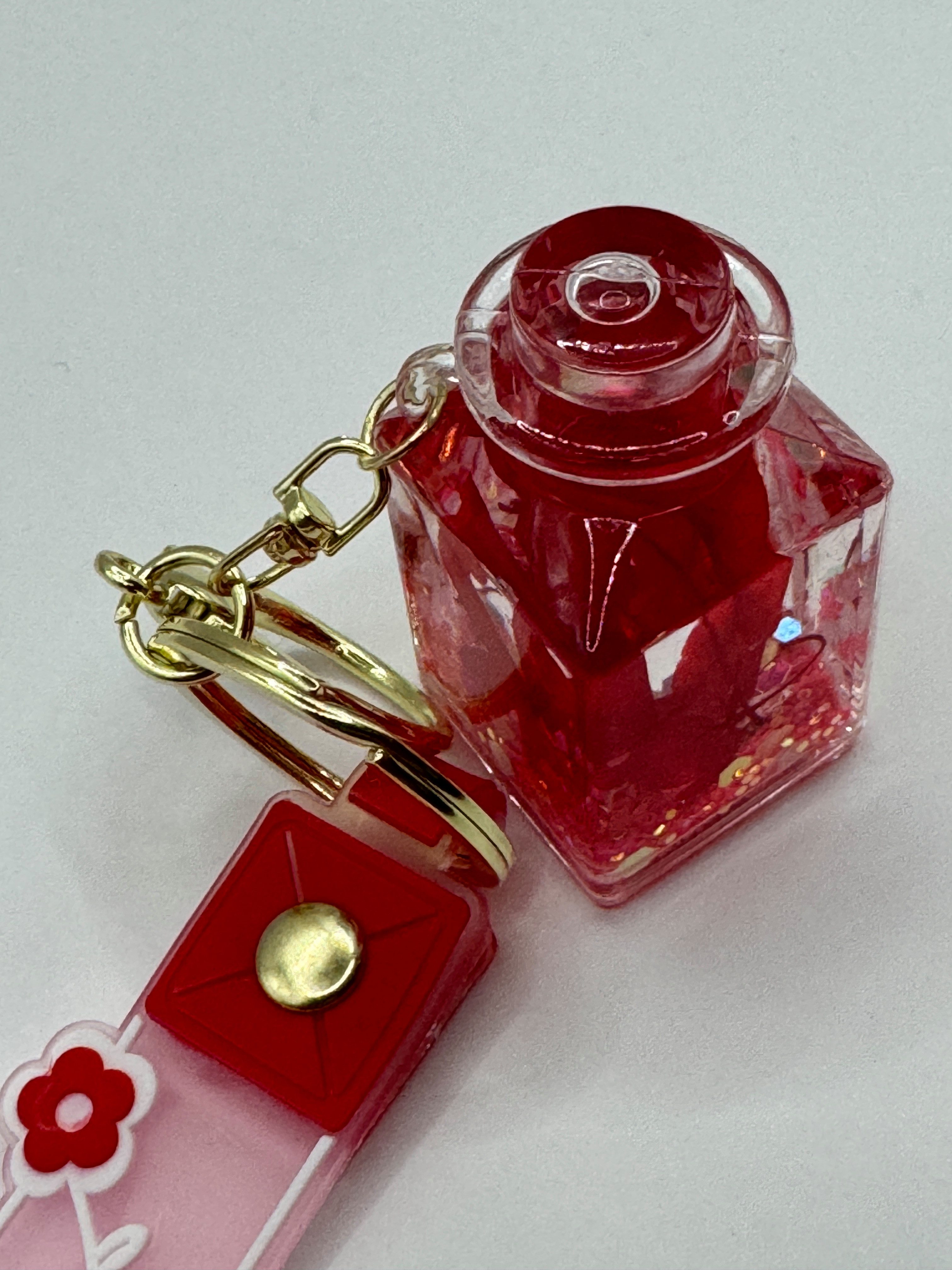 Stelby Schlüsselanhänger Romantischer Flaschen-Schlüsselanhänger mit Blume & Glitzerdeko, Acryl-Fläschchen mit Kunstblume, Glitzer & stabilem Metallring
