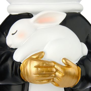 BRUBAKER Dekofigur Astronautin mit weißem Hasen - 33cm Weltraum Figur mit schwarzer Jacke (1 St., Große Skulptur mit verchromtem Helm), Handbemalte moderne Statue Astronaut - Gold, Schwarz und Weiß