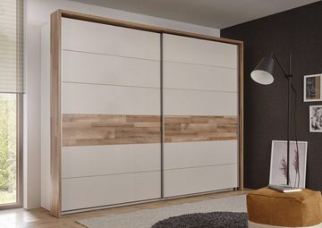 möbelando Kleiderschrank Carlynn Moderner Schwebetürenschrank aus Spanplatte in Champagner, Absetzungen in Montana Oak Nachbildung mit 2 Schwebetüren, 3 Konstruktionsböden und 3 Kleiderstangen. Breite 270 cm, Höhe 210 cm, Tiefe 60 cm