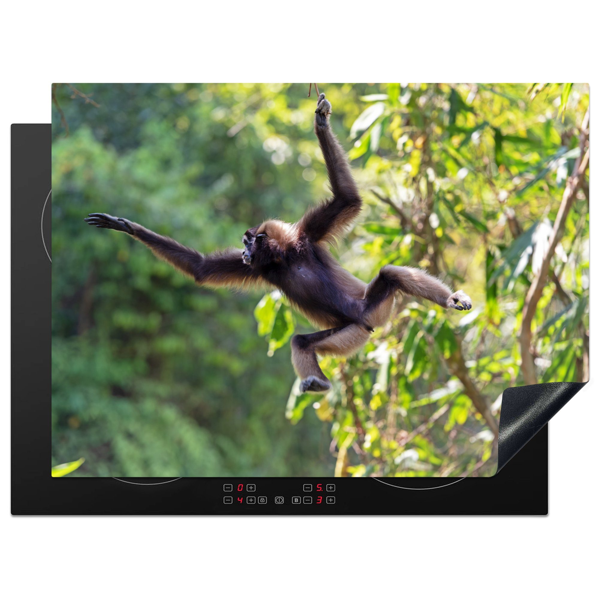 MuchoWow Herdblende-/Abdeckplatte Springender Affe im Dschungel, Vinyl, (1 tlg), 70x52 cm, Mobile Arbeitsfläche nutzbar, Ceranfeldabdeckung