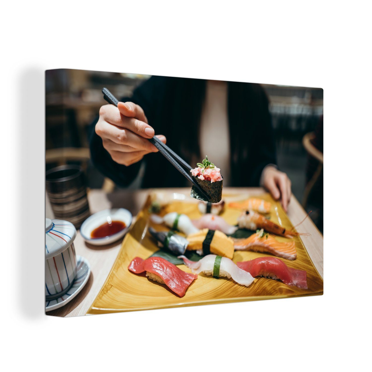 OneMillionCanvasses® Leinwandbild Nahaufnahme einer Frau, die Sushi aus der japanischen Küche isst, (1 St), Wandbild Leinwandbilder, Aufhängefertig, Wanddeko, 30x20 cm