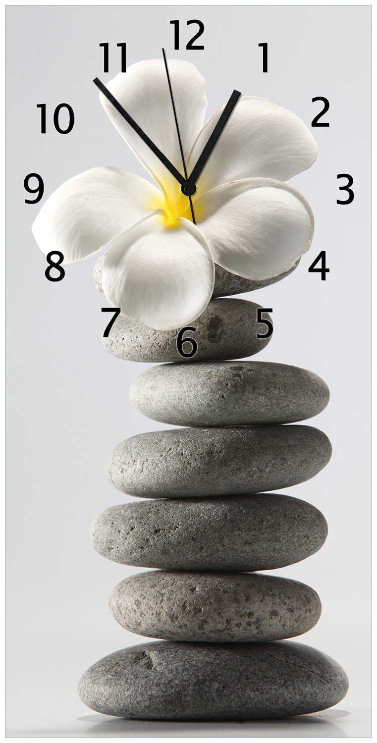 Wallario Wanduhr Blume auf gestapelten Steinen (Uhr aus Acryl)