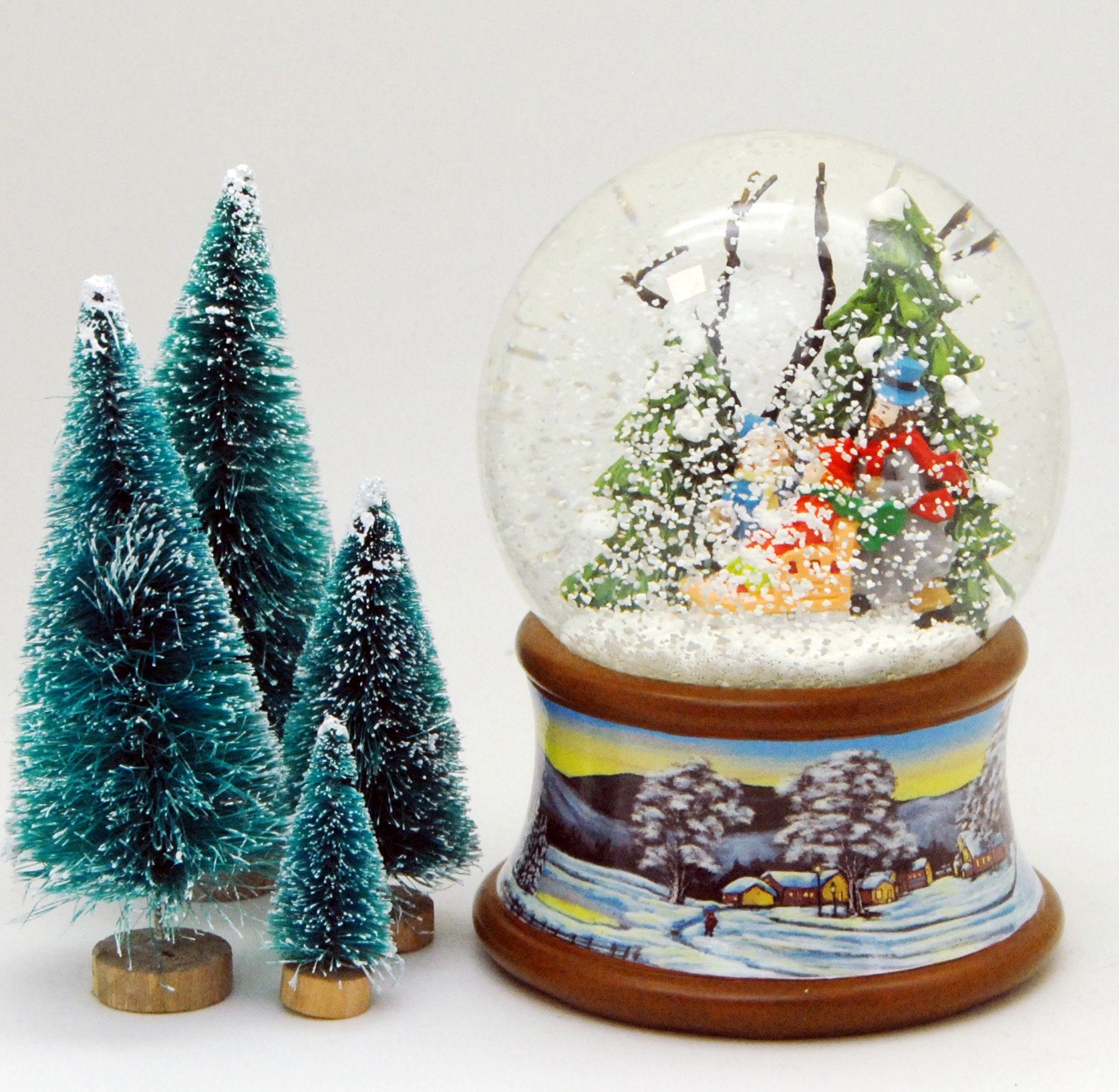 MINIUM-Collection Schneekugel Familie Schlitten Winterwald Winterlandschaft 10cm Spieluhr auf Sockel