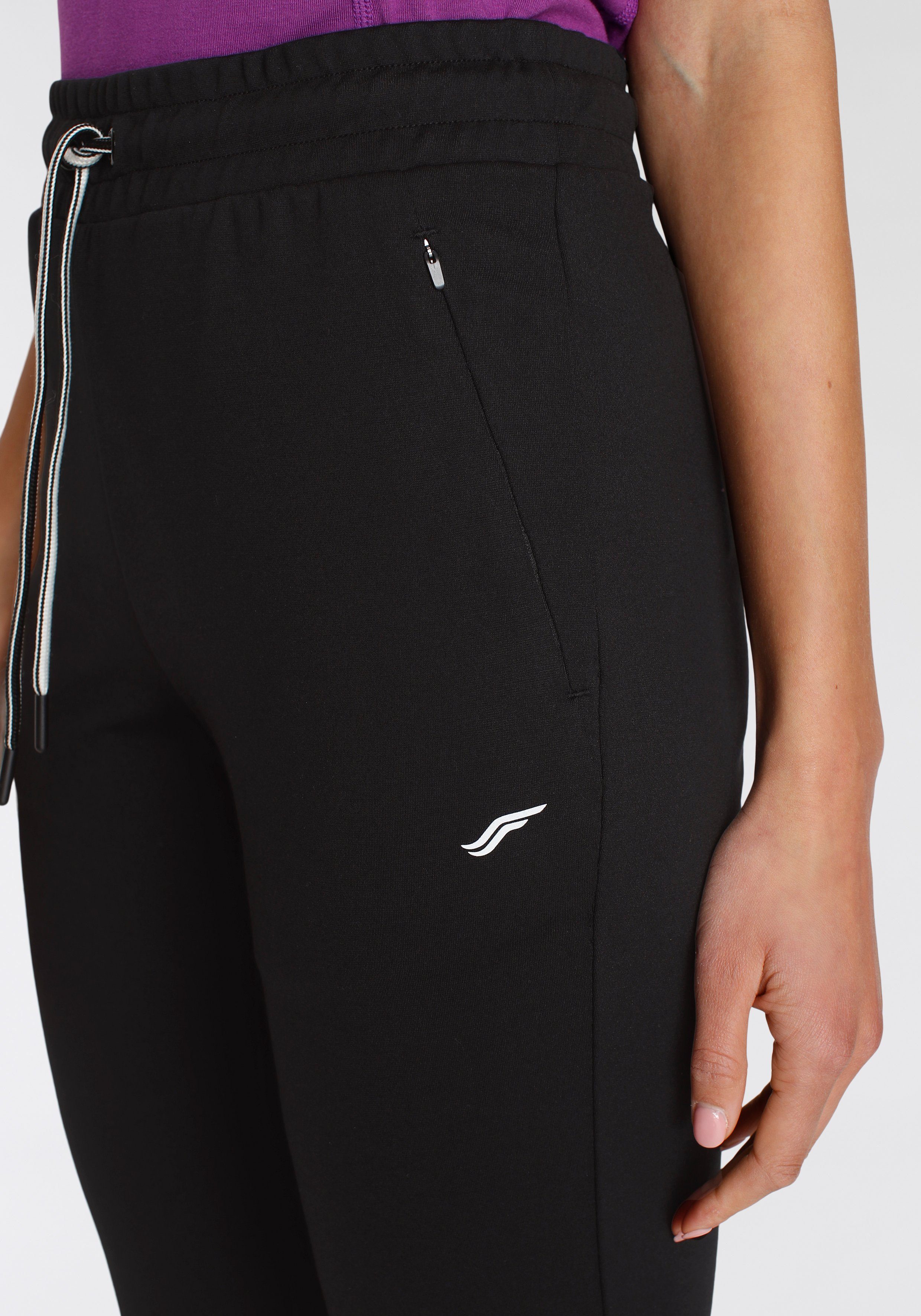 mit FAYN SPORTS Jogginghose Relaxed schwarz Reißverschlusstaschen Fit