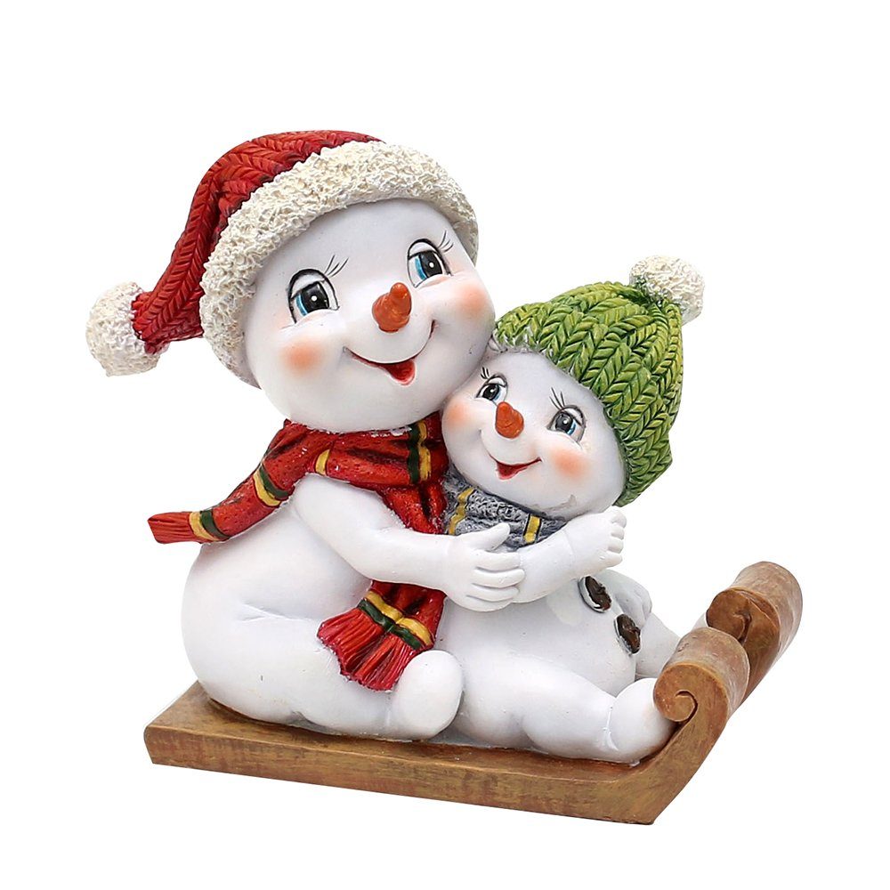 Dekohelden24 Dekofigur Schneekinderpaar - Schneemänner mit Mütze und Schal in rot-grün auf, Schlitten, L/B/H 14 x 7 x 12 cm